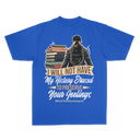 A royal blue short-sleeve t-shirt with a graphic print on the front. The graphic features a stylized illustration of a person in a black hoodie and sunglasses standing next to a stack of books, with a tan banner reading 'I WILL NOT HAVE My History Erased TO PRESERVE Your Feelinys' and the hashtag '#EndTheStereotypes'.